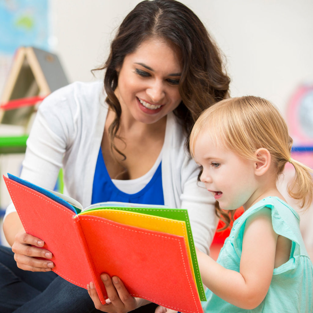 Lifestyle Square Teacher Reading Book With Child